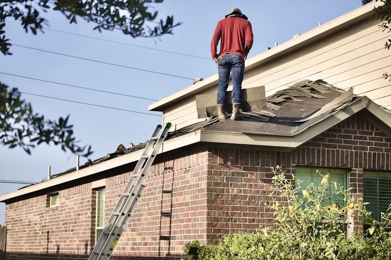 Professional roofer working on a residential roof in Yarmouth Station